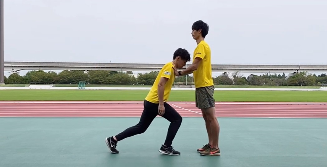 倒れる男性を支えている男性